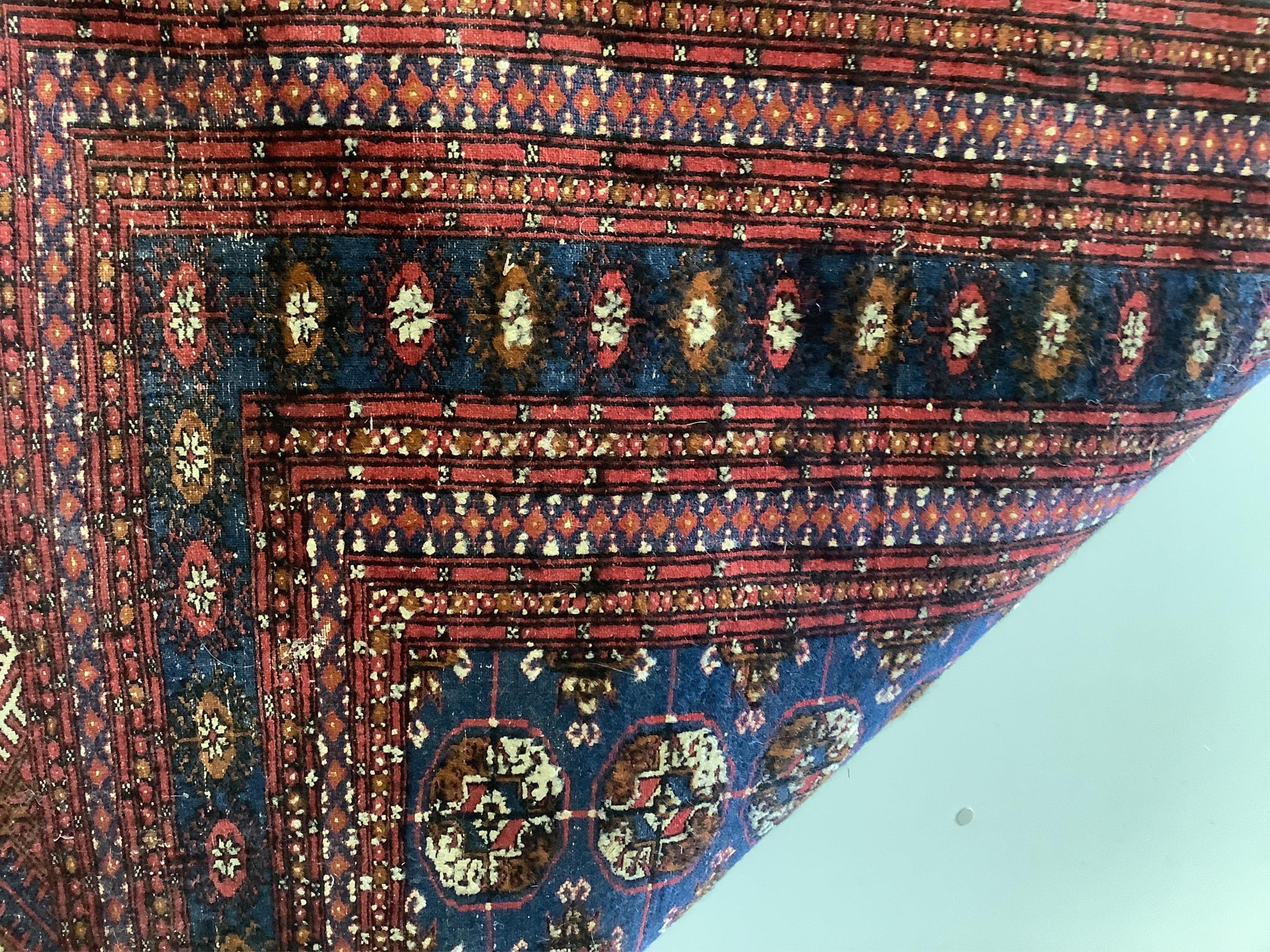 A Bokhara blue ground rug, 189 x 130cm